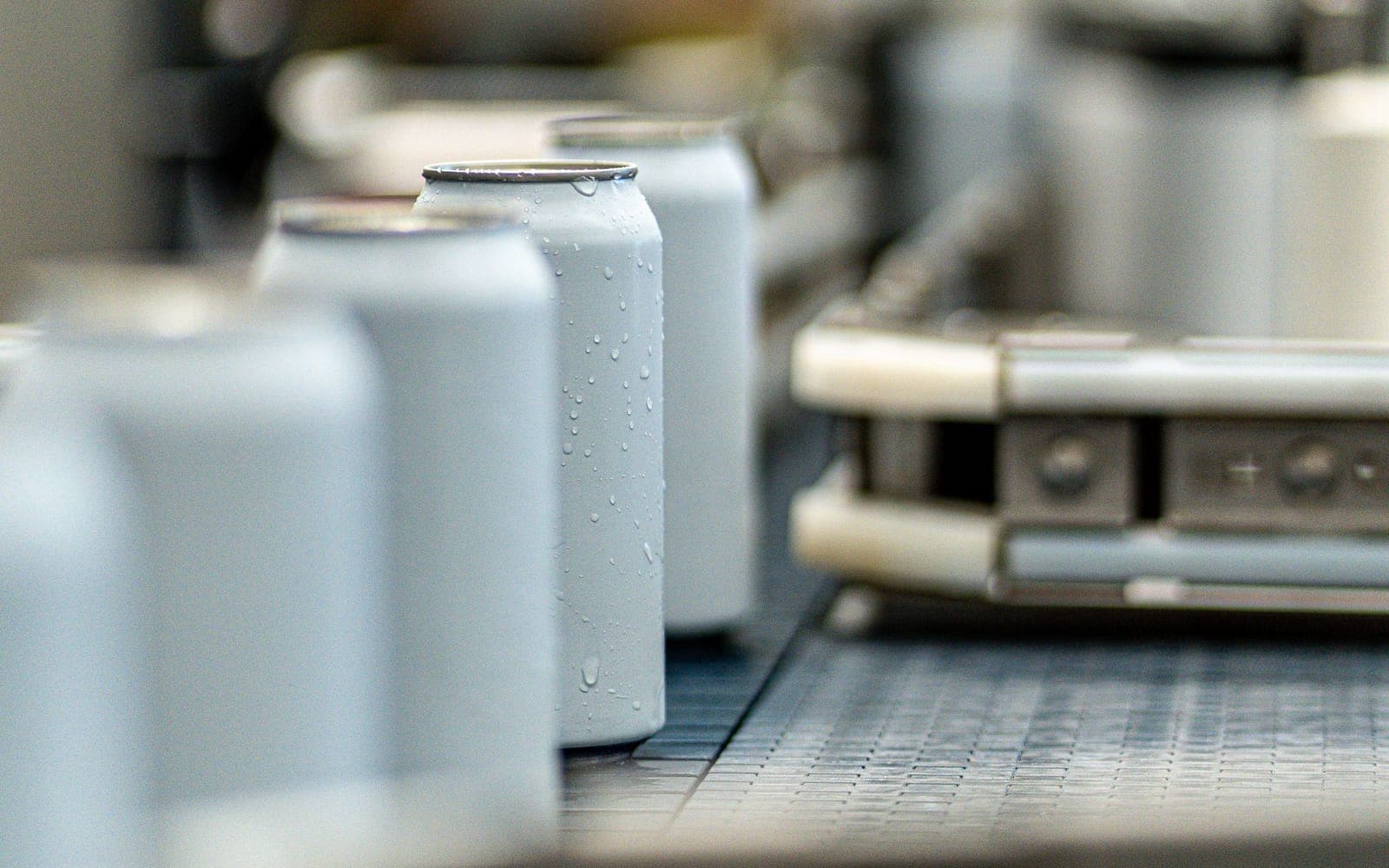 Cans moving along a conveyor