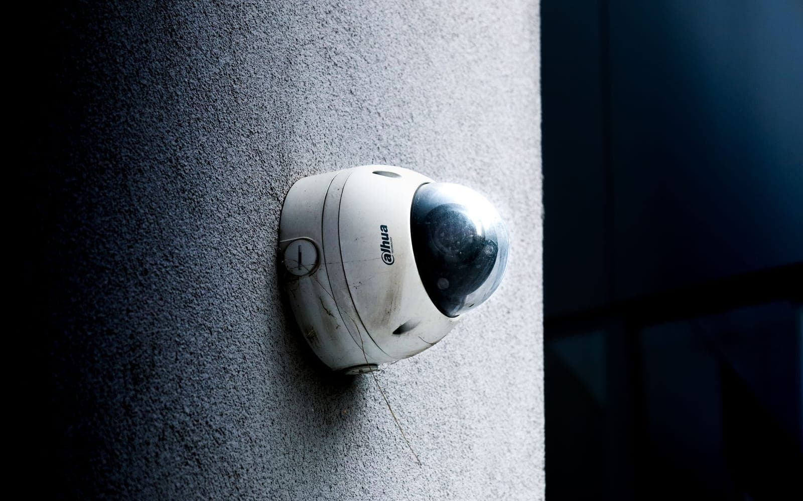 Dome security camera on a concrete wall